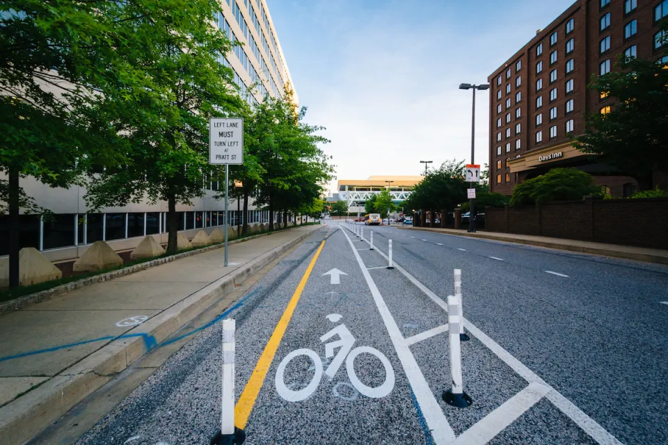 Bike lane protected by plastic delineators on street in downtown Baltimore, Maryland.